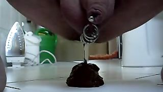 guy with piercings in his cock taking a shit