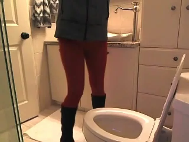 Teen brunette girl reads a magazine while she's pooping in the toilet....