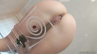 Licking brown shit from a glass table