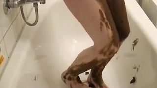 Busty MILF rubbing poop on her body