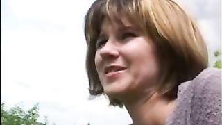 Mature woman pooping in nature