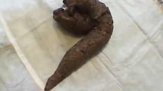 Big turd on a newspaper while smoking