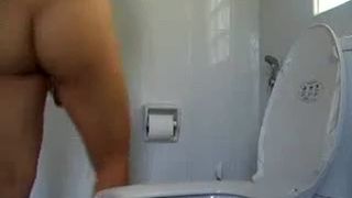 College girl pooping over the toilet