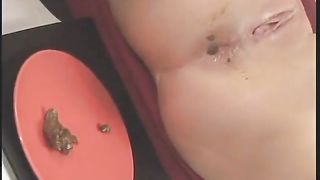 Horny MILF pooping on a red plate