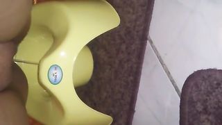 Chubby woman shitting in yellow potty