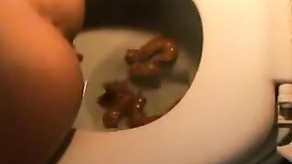 Four tiny pieces of poop in the toilet