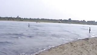 Smearing shit with sand on her naked body