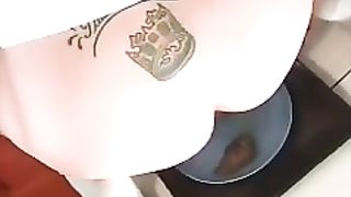 Tattooed brunette shitting on a plate