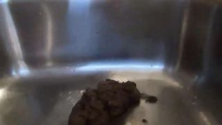 Hot brunette babe shitting in the sink