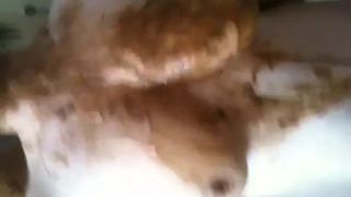 Mature chubby woman rubbing poop on her body