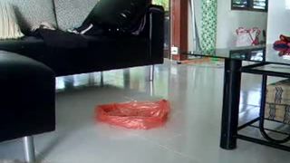 Petite girl pooping in a plastic bag