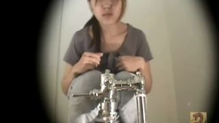 Young Asian in public bathroom