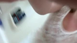 Horny housewife fingering her pussy while peeing in the tub