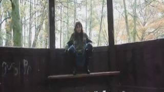 Young teen shitting outdoor on a wooden bench