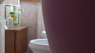 Hairy girl pooping over the toilet