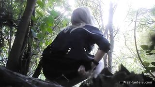 Pretty blonde peeing in a forest at a festival