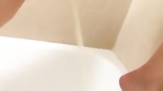 Hairy girl peeing in the tub while standing