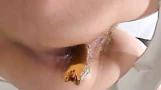 Sexy blonde girl sitting on a homemade toilet