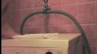 Tattooed girl shitting on a washing machine