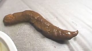 Beautiful teen pooping a very long turd