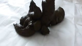 Sweet MILF shitting with a tiny dildo into her ass