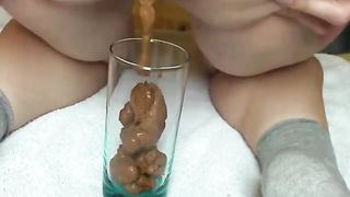Hot babe with big ass is pooping into a glass