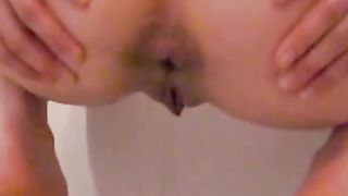 Hot redhead shitting over a toilet