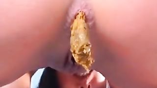 Teen girl shitting a yellow turd between her heels