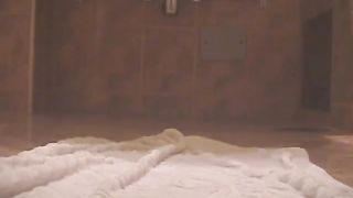 Brunette hottie shitting on a white towel