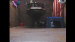 Sweet girl pooping in doggy style in the bathroom