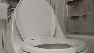 Beautiful college girl pooping and peeing over the toilet