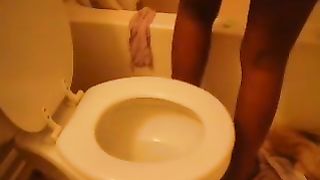 Sexy black girl pooping over the toilet