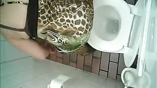 Fat brunette is sweaty after shitting in the toilet