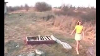 Sexy blonde shitting on top of a big rock