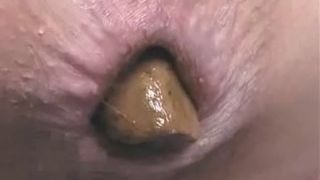 Close up of a Chinese girl that's pooping a monster turd