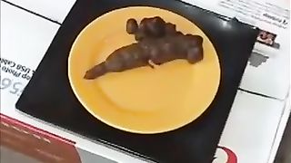 Perfect brunette model pooping on a yellow plate
