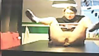Young brunette pooping on top of a wooden table