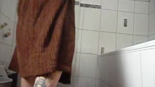 Tattooed amateur woman pooping on the bathroom floor