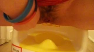 Hairy girl pooping in a white potty in close up