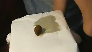 Amateur teen pooping on a white table