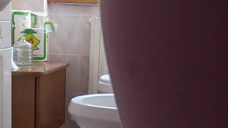 Hairy MILF pooping over the toilet for her fans