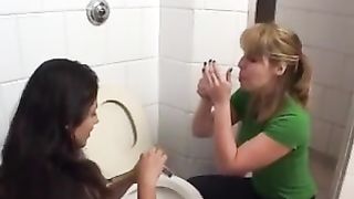 Two sexy girls eating poop from a toilet