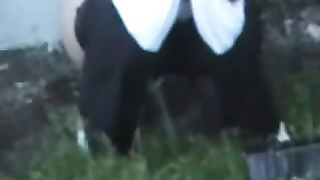 Two sexy co-workers peeing together outdoor