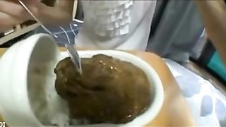 Eating liquid poop with a metallic spoon