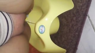Shaved girl pooping in a yellow potty