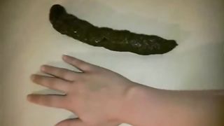 Beautiful blonde pooping on a wooden table