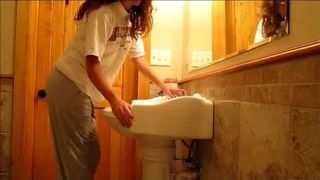 Cute girl pooping sink to play with her poop