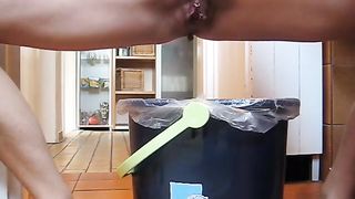 Tattooed pierced girl pooping in trash can