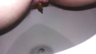 Sexy wife taking a big turd in close up