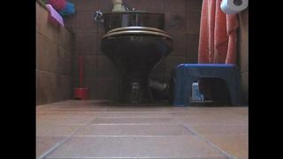 Young brunette pooping in doggy style position